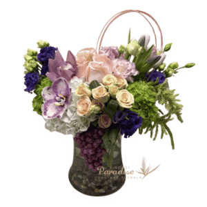 Transport to the romance and magic of Italy with this purple floral arrangement.  It includes roses, hydrangeas, orchids, lisianthus, tulips, spray roses, and greenery arranged in a glass container.