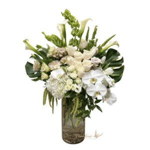 This stunning angelic white arrangement is a perfect way to show up for the people that you love and hold dear to your heart. Filled with roses, spray roses, hydrangea, orchids, calla lilies, lisianthus, bells of ireland, and greenery.